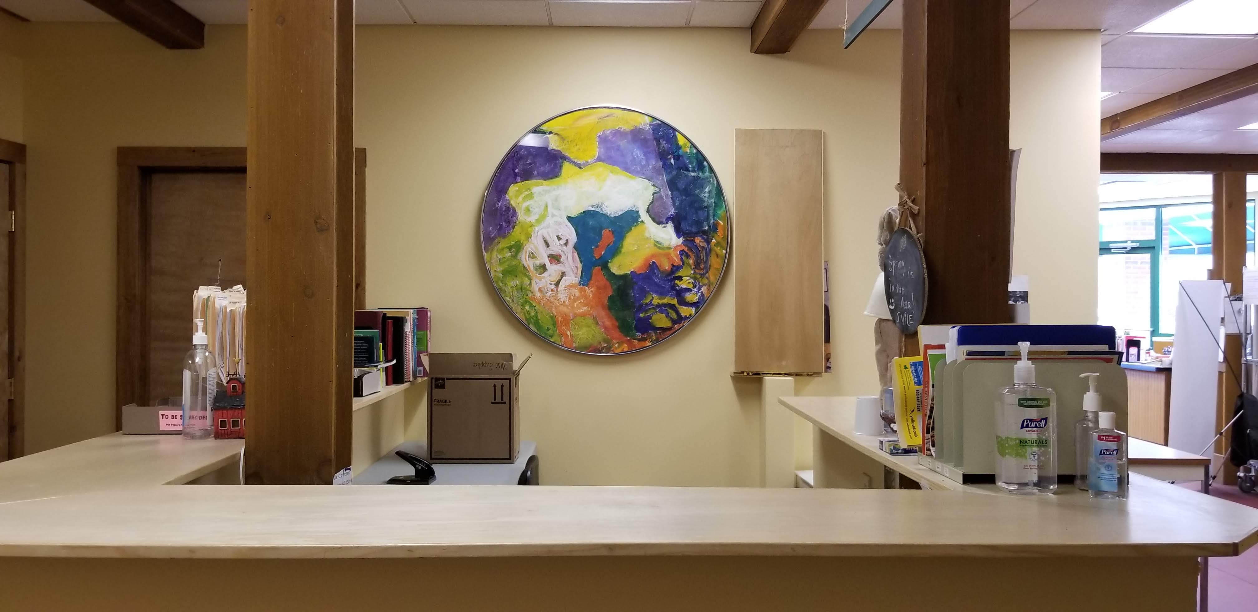 Circular oil painting over clinic check-in desk